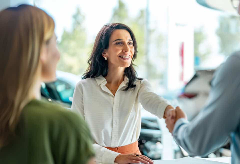 Woman shakes hand of salesman