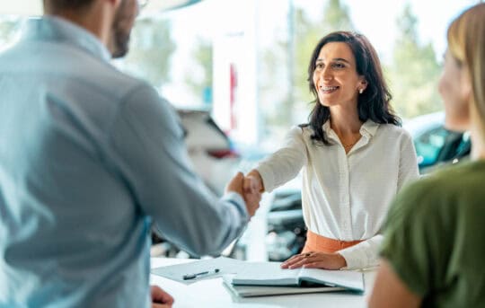 Woman shakes hand of salesman