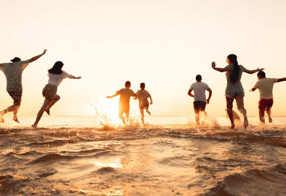 Friends at the beach splashing